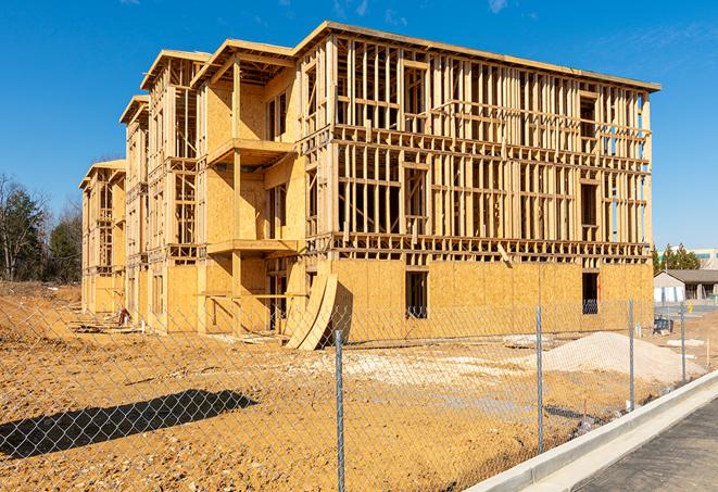 a close-up of temporary chain link fences enclosing a job site, signaling progress in the project's development in Jonesborough